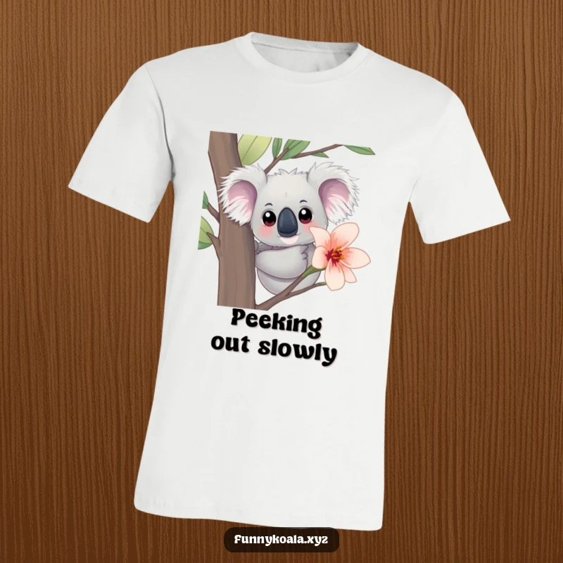 Funny Koala T-Shirt: A curious koala with large eyes peeks out from behind a vibrant eucalyptus flower, a humorous and cute design.